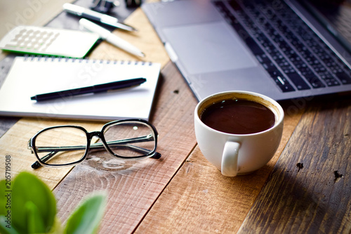 Desk work coffee cup and laptop notebook pen on wooden table
