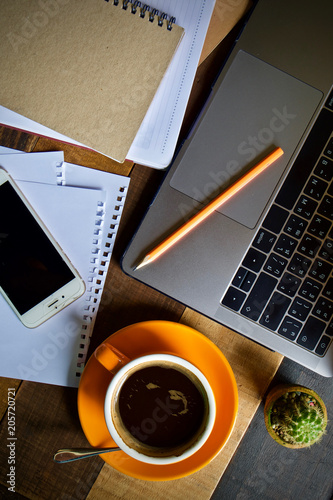 Desk work coffee cup and laptop notebook pen on wooden table