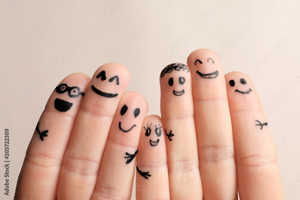 Fingers with drawings of happy faces against light background. Unity concept - obrazy, fototapety, plakaty 