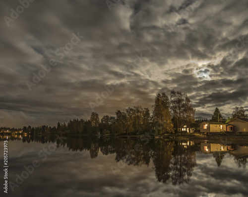 night lake scandinavian forest house light mirrored in water