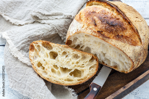 Canvas Print Cut a loaf of artisanal bread on sourdough.