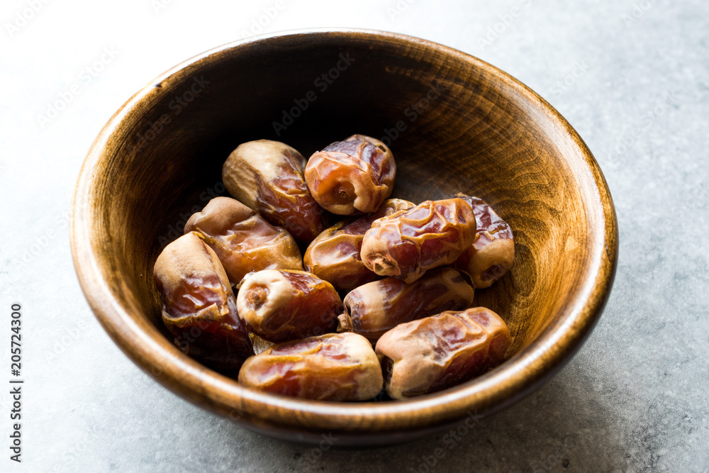 Dried date palm fruits or kurma, ramadan ( ramazan ) Medjool food in wooden bowl. Dried date palm fruits or kurma, ramadan ( ramazan ) Medjool food in wooden bowl.