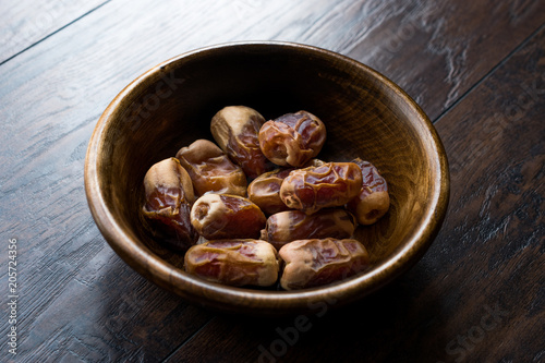 Dried date palm fruits or kurma, ramadan ( ramazan ) Medjool food in wooden bowl.