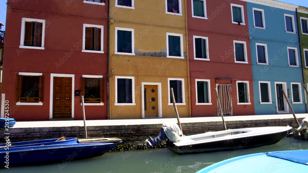 Multicolored buildings in street on Burano island in Venice Lagoon, Italy
