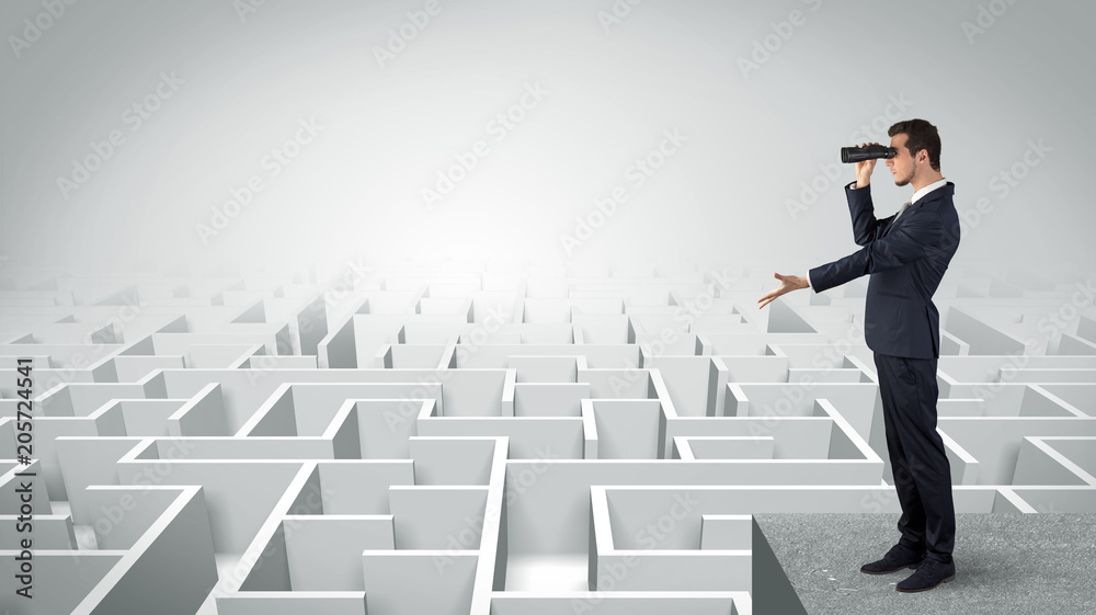Businessman standing on maze and looking forward to the future concept
Businessman standing on maze and looking forward to the future concept