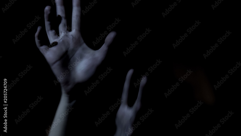 Victim hands stretching out in darkness, begging for help, scary thriller Victim hands stretching out in darkness, begging for help, scary thriller
