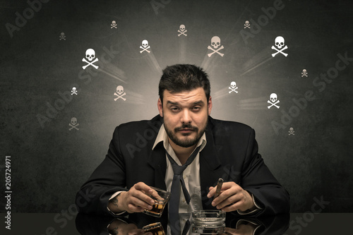 Loser drunk man sitting at table with skulls concept around 