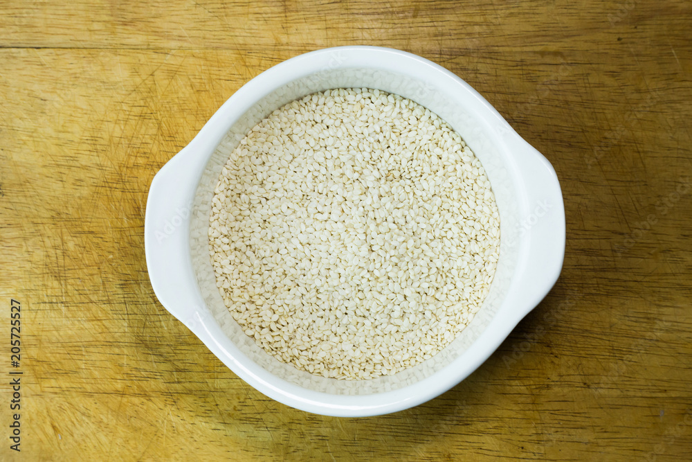 white Sesame seeds on a old wooden table.. white Sesame seeds on a old wooden table..
