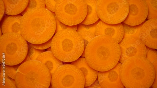 Carrots slices rotating, close-up, top view, 4K