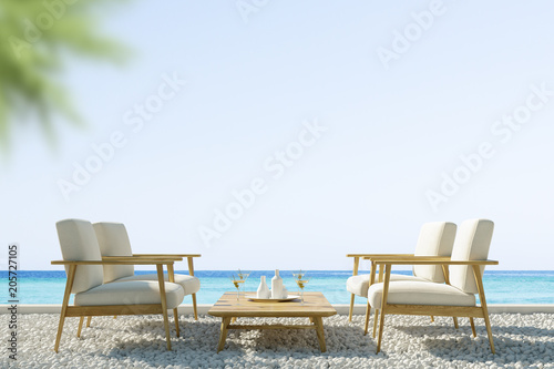 Two white sofas on an ocean shore