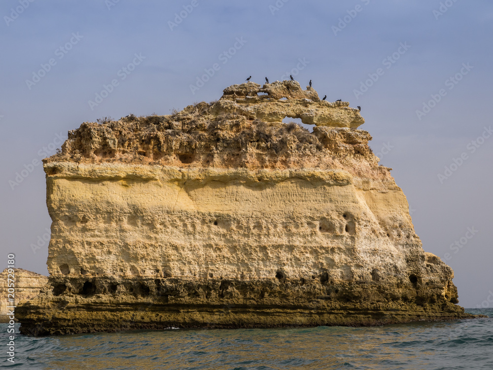 view of a rock islet on Marinha beach from a boat Algarve, Portugal