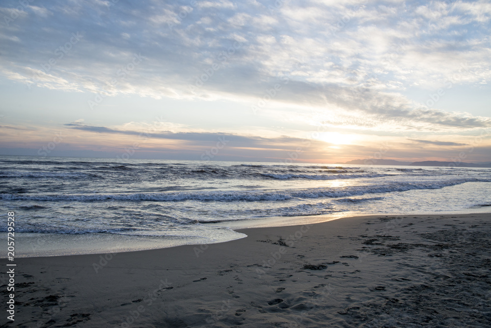 Waves at sunset, the beach at Italy - Summer season