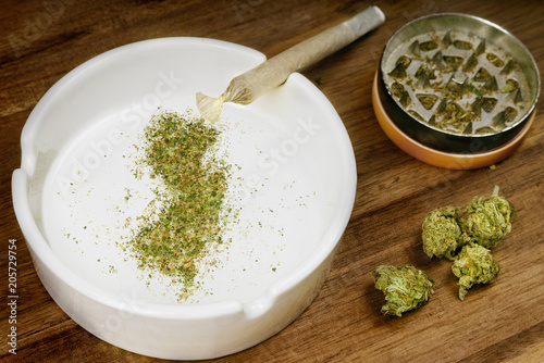Ground weed in the shape of New Jersey with a joint. (series)