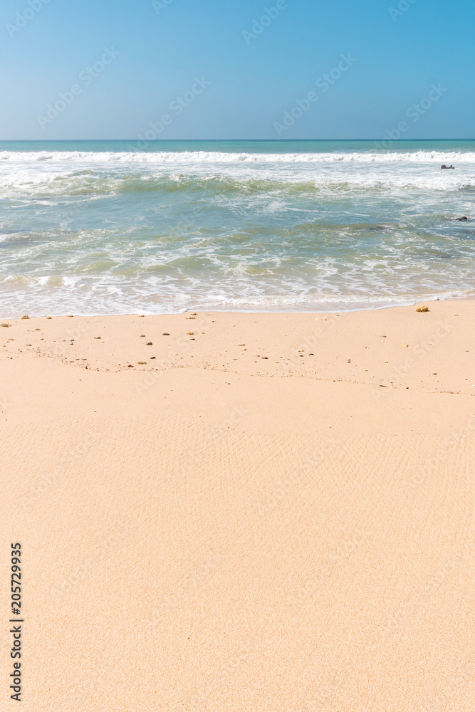Tropical beach background with soft wave, white sand and blue sky