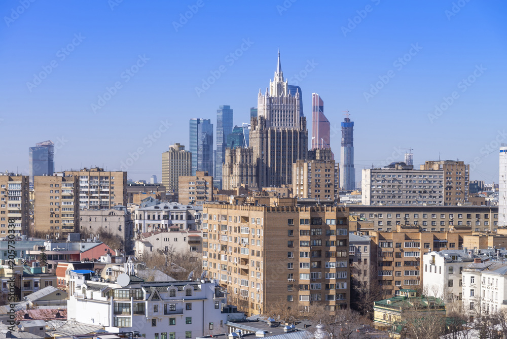 Fototapeta premium view of Moscow cityscape, old historical town and urban skyscrapers (Moscow International Business Center background) with sunny blue sky, Moscow city, Russia
