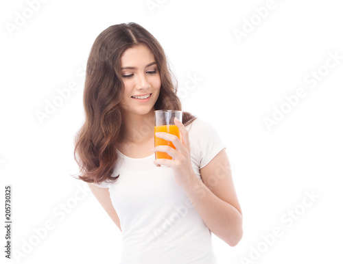 Portrait of a woman drinking orange juice. Orange juice in glass