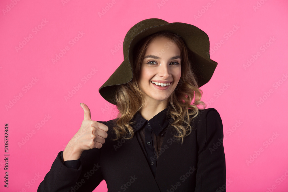 beautiful young joyful girl in a black jacket and hat on a pink background beautiful young joyful girl in a black jacket and hat on a pink background