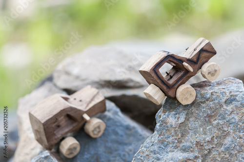SUV toy car in nature / Wooden SUV, toy car in an extreme landscape.