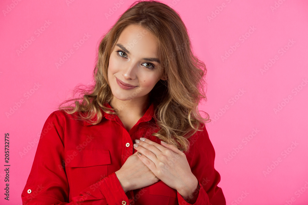 young joyful beautiful girl in red attire on a pink background young joyful beautiful girl in red attire on a pink background