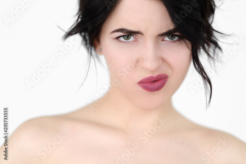 emotion face of disrespect. discontented annoyed displeased woman. young beautiful brunette girl portrait on white background.
