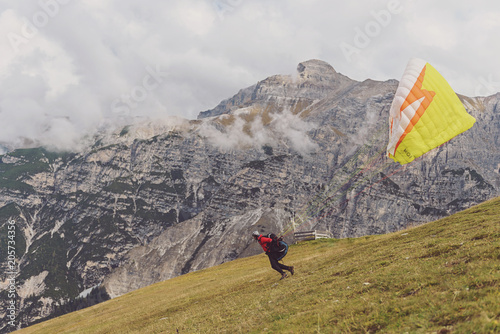 Fototapeta Naklejka Na Ścianę i Meble -  Paragliding in the Alps. The takeoff.