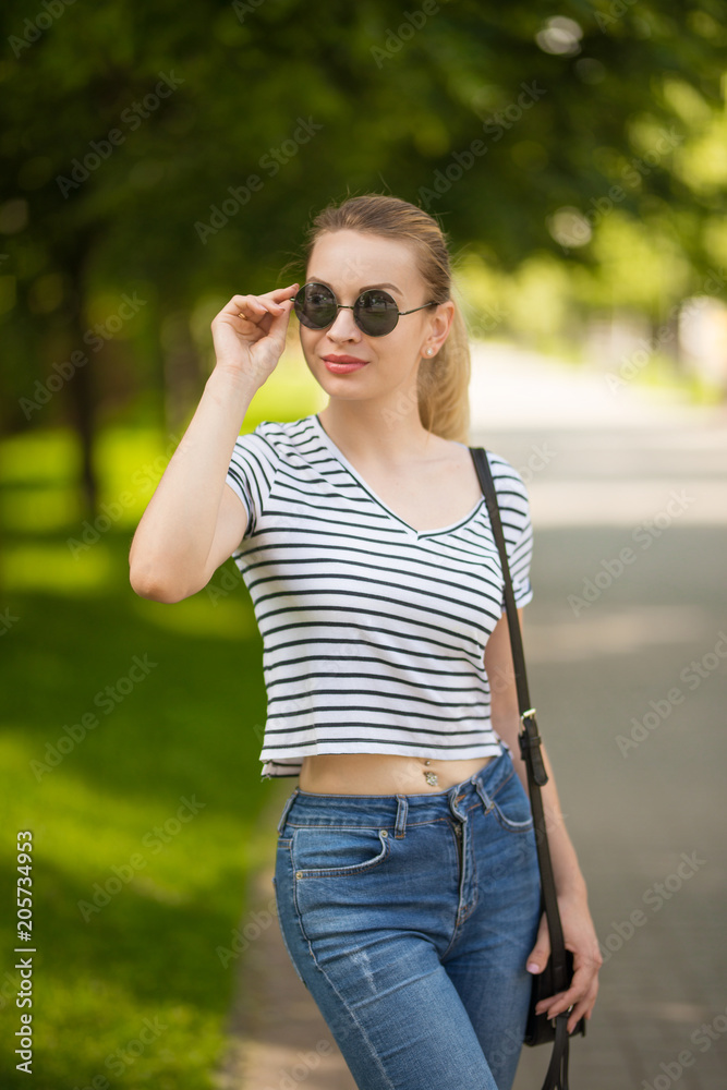 Merry girl hipster in glasses in the city walking Merry girl hipster in glasses in the city walking