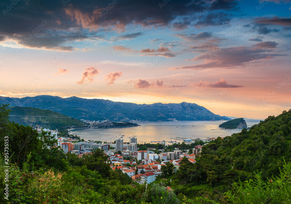Panoramic landscape of Budva riviera in Montenegro at sunrise. Dramatic morning light. Balkans, Adriatic sea, Europe. View from the top of the mountain. 