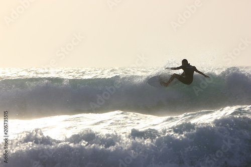 surfer riding a wave in Fuerteventura, Canary Islands, Spain