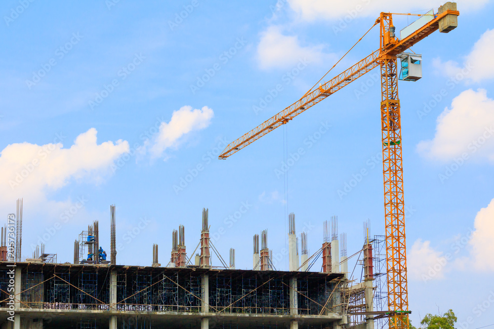 construction workers site and  building of housing at laborer work outdoor which has tower crane blue sky  background with copy space add text