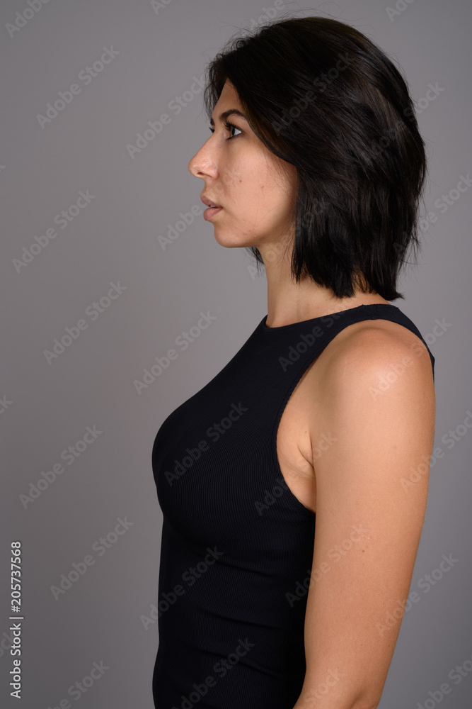 Young beautiful woman against gray background Young beautiful woman against gray background