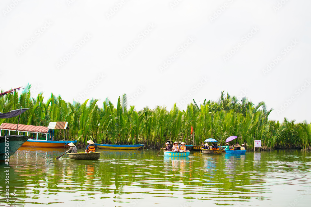 Obraz premium HOI AN, QUANG NAM, VIETNAM, April 26th, 2018: Tourists visit water coconut forest in Hoi An