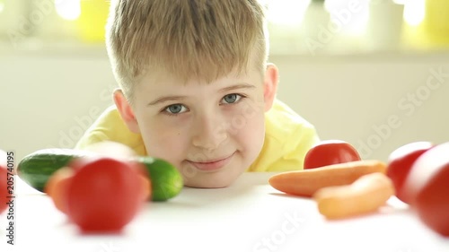 Portrait of a child with vegetables. Happy child eating healthy vegetables. Cute kid and healthy food.