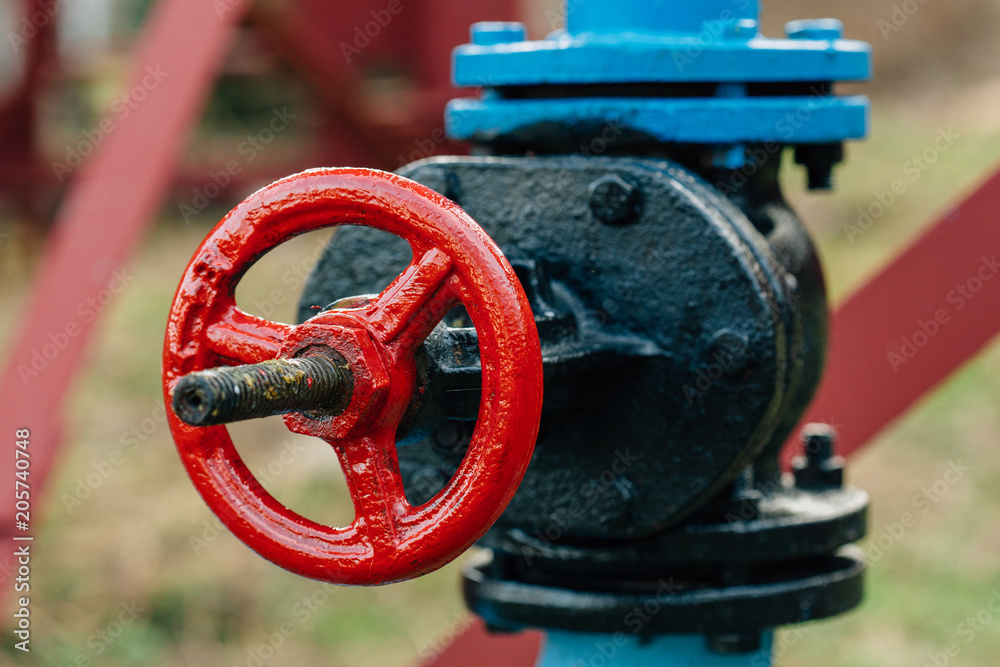 close-up of the valve plug in the field on a sunny summer day close-up of the valve plug in the field on a sunny summer day