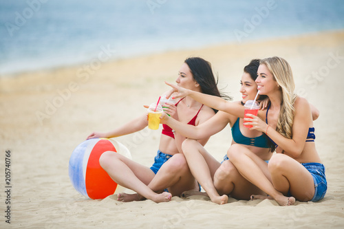 Group of young cheerful girls having fun on the beach