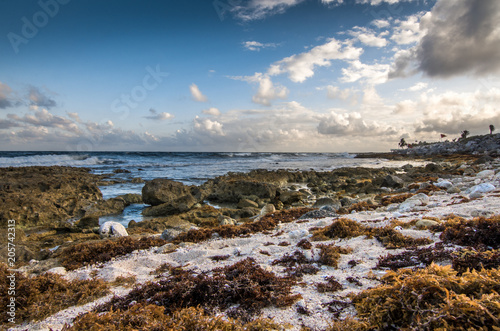 Beautiful rocky beach at dusk and sea waves