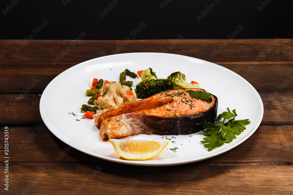 Dish of fish (trout) on a dark background Dish of fish (trout) on a dark background