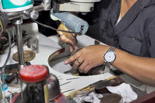 Goldsmith at work with traditional tools - selectived focus photo