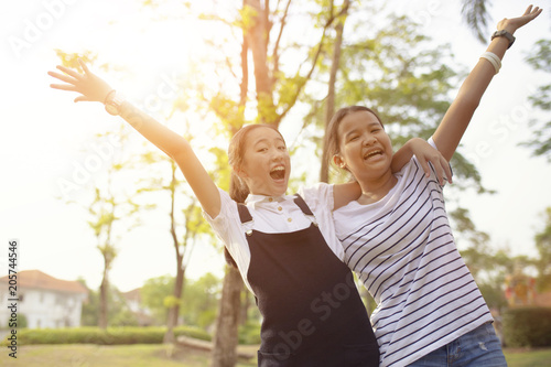 two asian teenager laughing with happiness emotion in green natural park © stockphoto mania