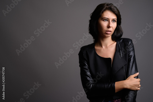 Young beautiful woman against gray background
