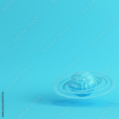 Fototapeta Naklejka Na Ścianę i Meble -  Blue abstract planet with rings on bright blue background in pastel colors