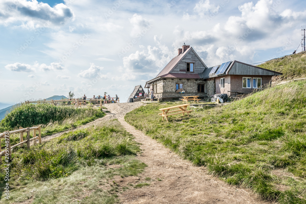 Fototapeta premium Hostel for tourists on the tourist trail on the top of the mountain