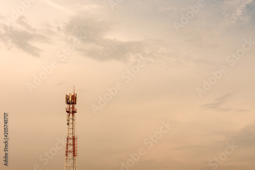 Antenna at sunset with clouds background.