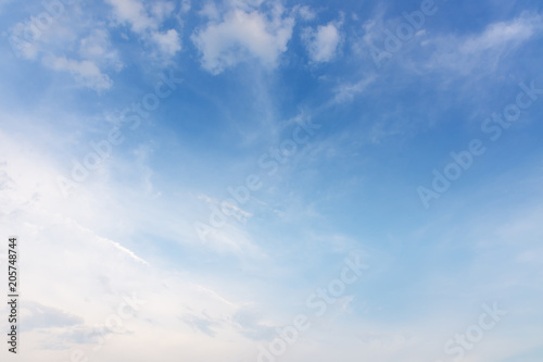 Sunset with sun rays and clouds background.