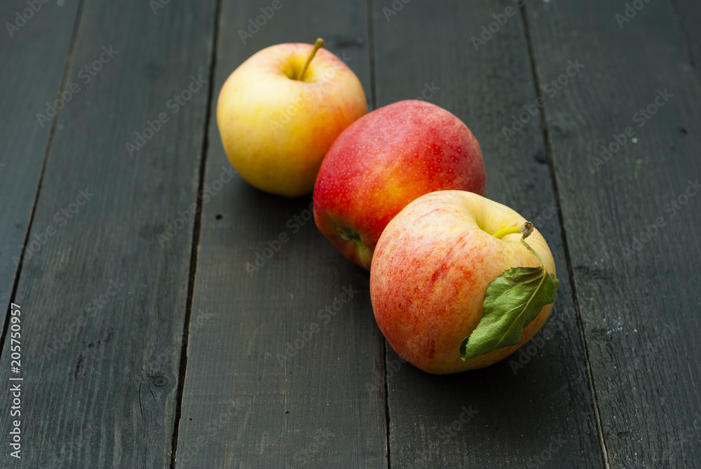 apples on black wooden table background apples on black wooden table background