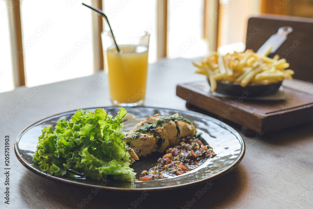 Lunch in restaurant. Meat with salad and glass of juice. Lunch in restaurant. Meat with salad and glass of juice.