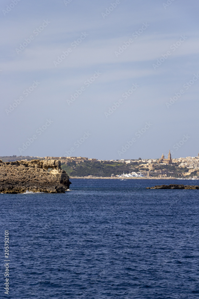 Mediterranean Maltese seascape with view to Mgarr Harbor in the distance, Gozo, Malta