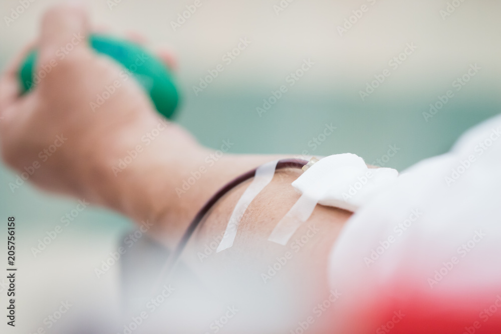 Health and Medical : Blood donor donation with bouncy ball holding in hand. Blood donation occurs when person voluntarily has blood drawn used for transfusions. Image for World blood donor day June 14