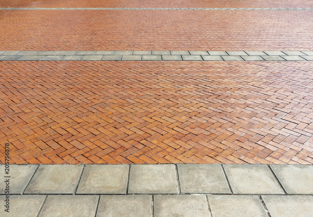 Fototapeta premium Red brick paving stones on a sidewalk