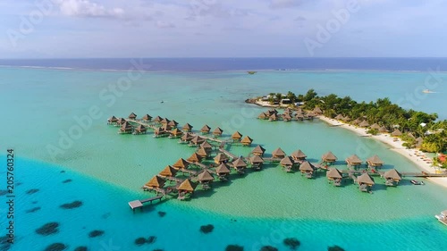 Aerial view of tropical paradise of Bora Bora island, turquoise crystal clear water of scenic blue lagoon, typical over water bungalows, Matira Point - South Pacific Ocean, French Polynesia from above photo