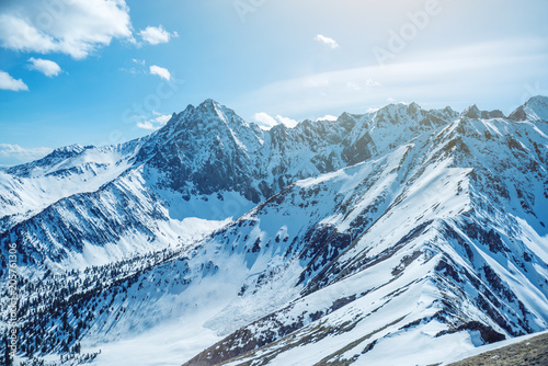 Landscape of snow-capped peaks of the rocky mountains in Sunny weather. Concept of nature and travel